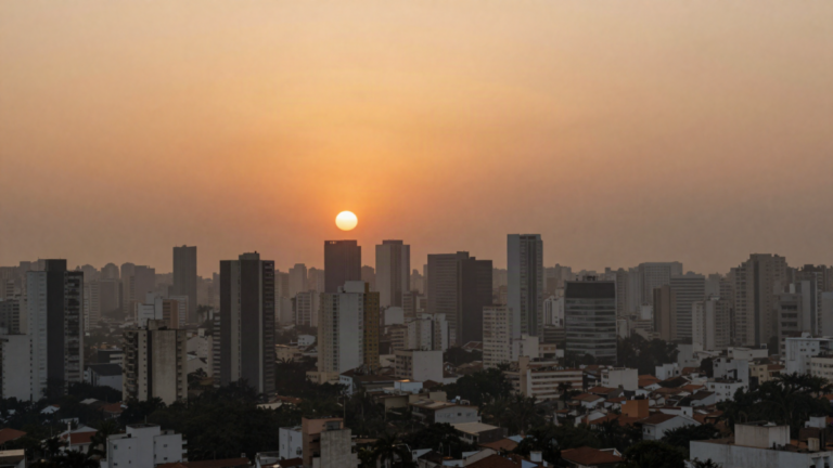Neblina de poluicao sobre cidade brasileira ao por do sol com ceu alaranjado